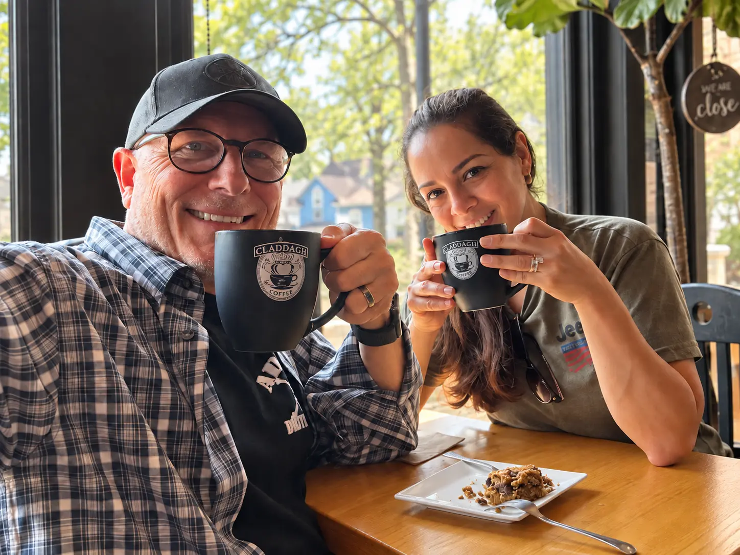 Tim and Ceci holding coffee mugs together at Claddagh Coffee in Saint Paul